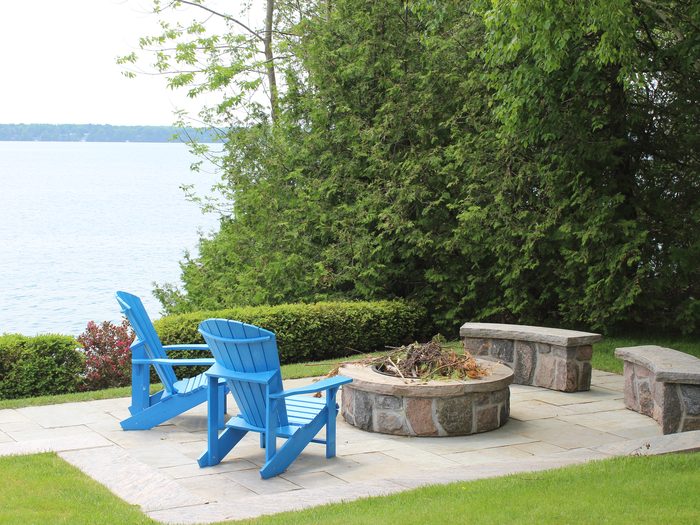 Lakefront patio with flagstone and fire pit by Spring ECO Construction, Simcoe County Ontario