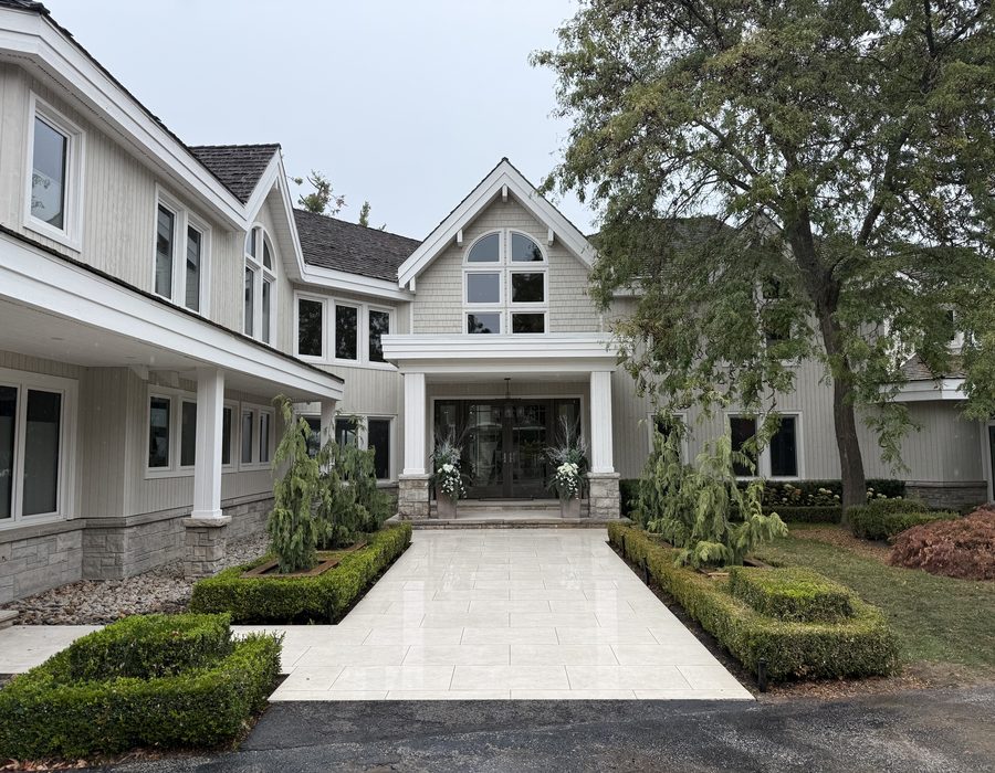 Estate landscape construction project by Spring ECO Construction — formal entry with interlock walkway, weeping cedars, and clipped boxwood